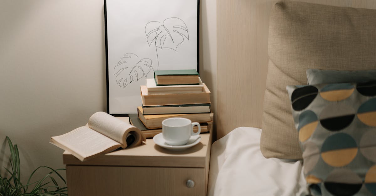 White crumpled blanket in dark bedroom next to window with blinds at vibrant sundown