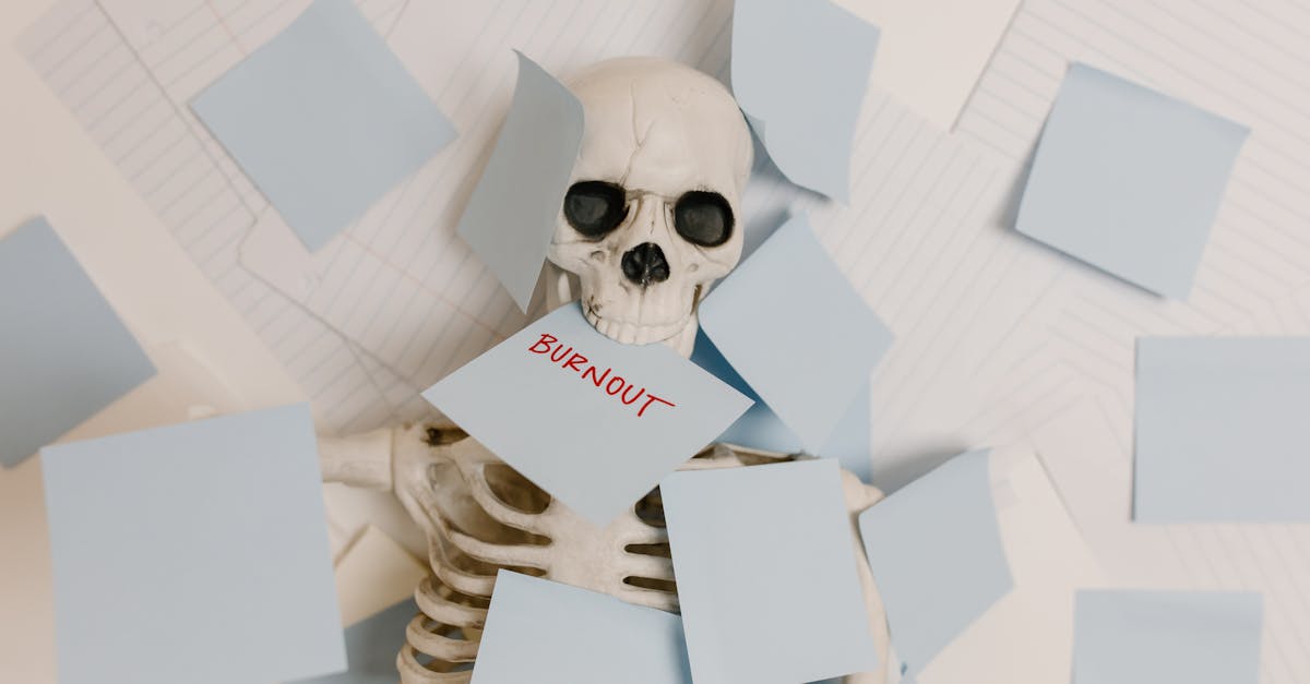 A skeleton covered in sticky notes with 'burnout' on one, symbolizing work stress and exhaustion.