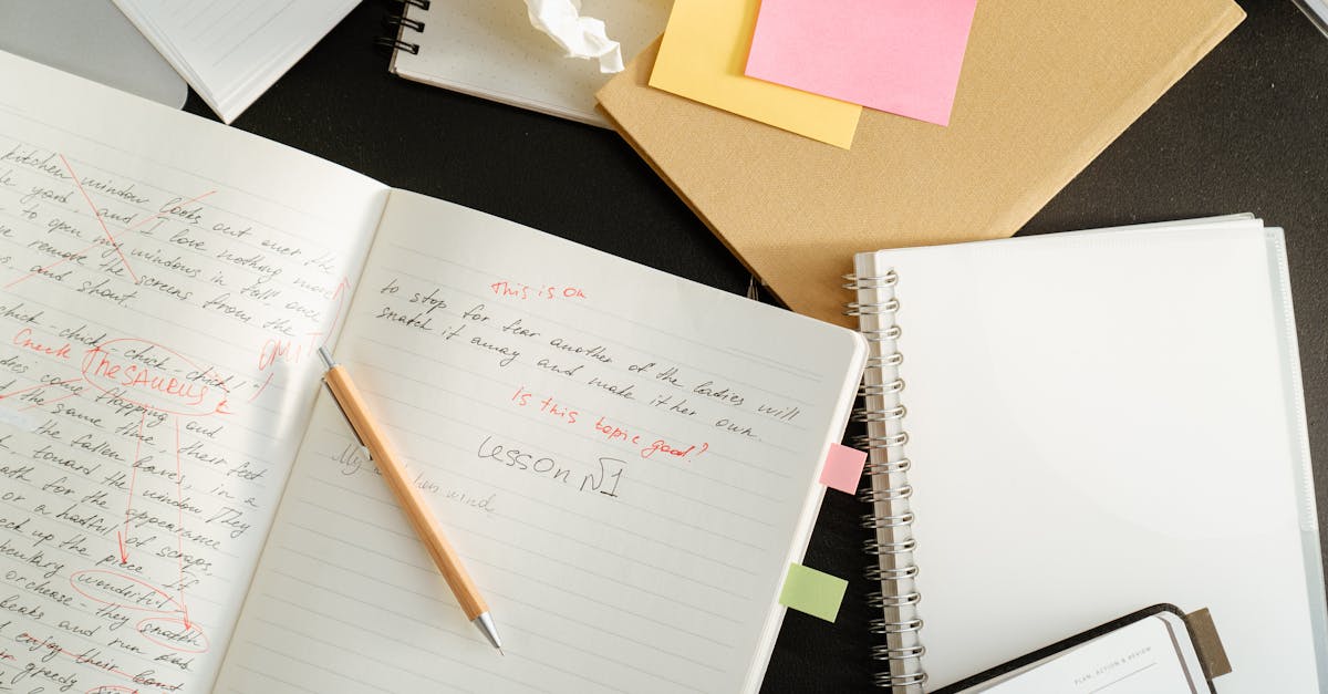 A cluttered desk with notebooks, sticky notes, and stationery for educational purposes.