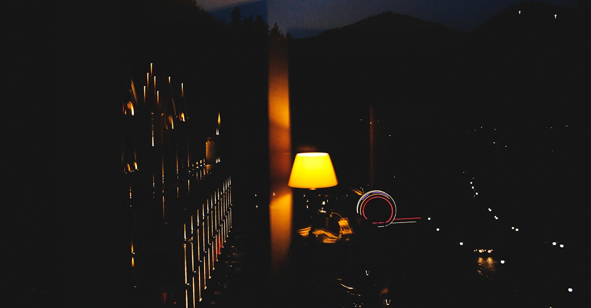 Warm bedroom light casting glow over city view, enhancing night ambience.