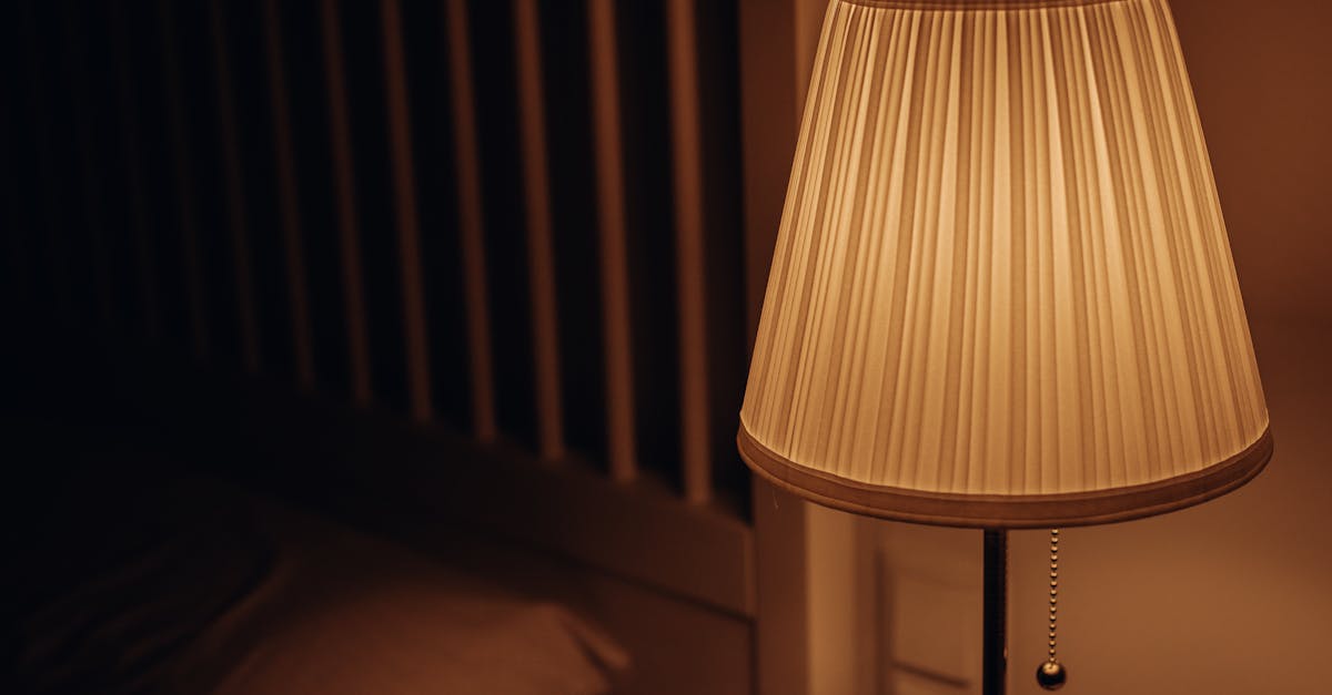 A dimly lit bedside lamp creating a warm and cozy atmosphere in a bedroom setting.