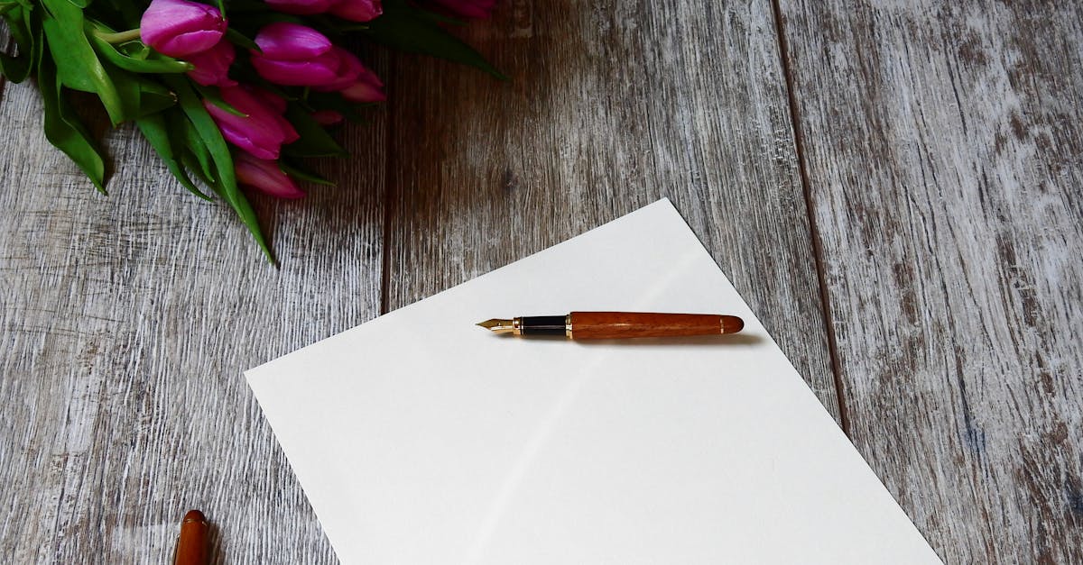 A blank note with a fountain pen and purple tulips on a wooden table, ideal for personalized messages.