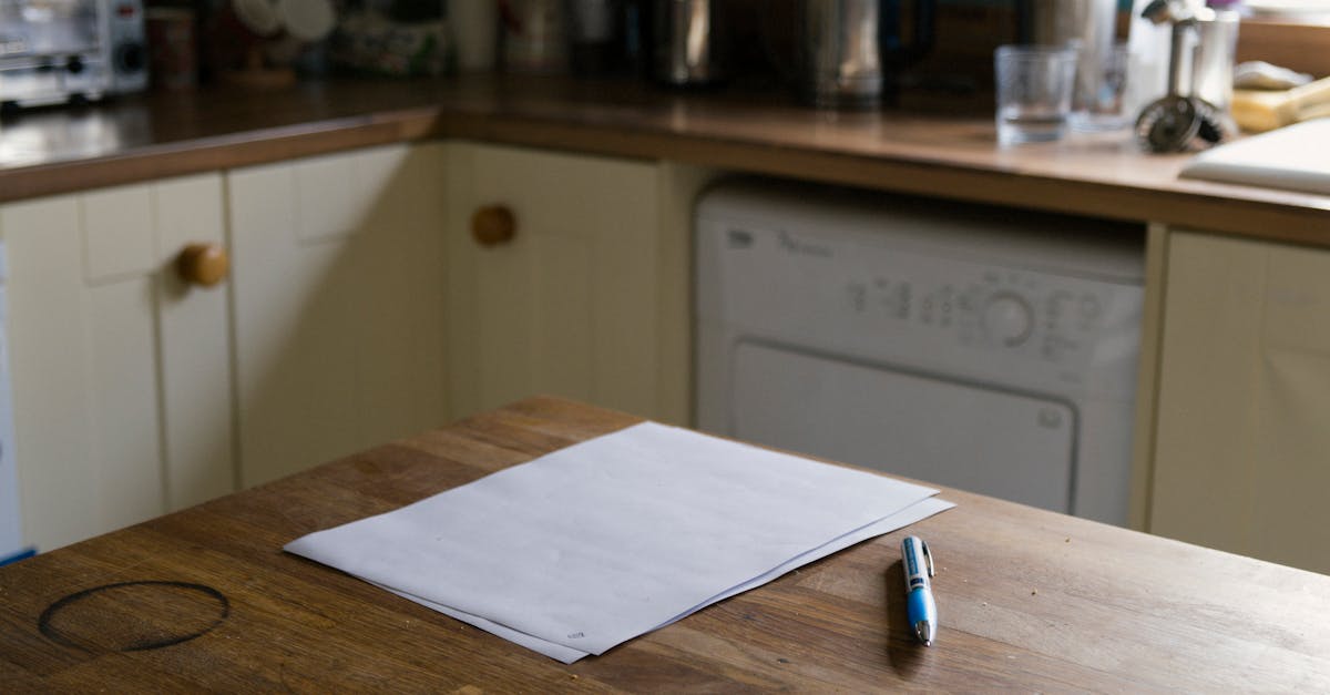 A serene kitchen scene featuring a blank paper and pen on a rustic wooden table, perfect for writing ideas.