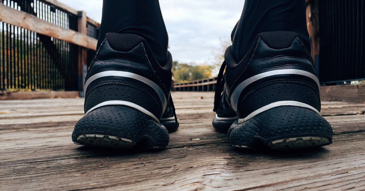 Close-up of athletic sneakers on a wooden bridge, capturing a runner's morning exercise routine.